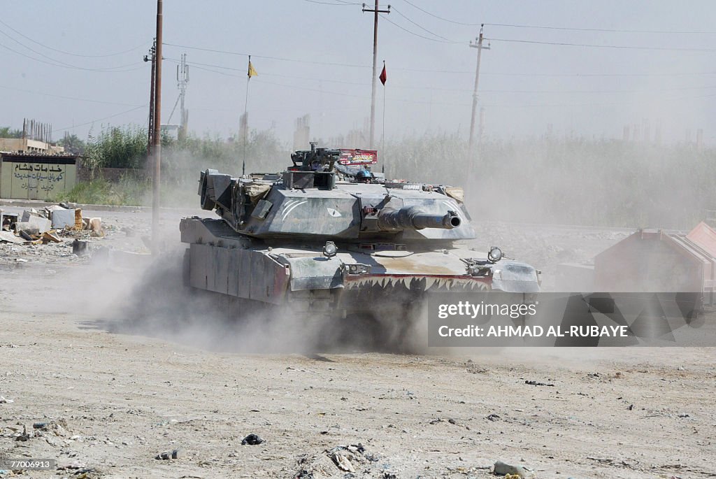 Army Abrams tank guards a meeting between Sunni and Shiite tribe ...