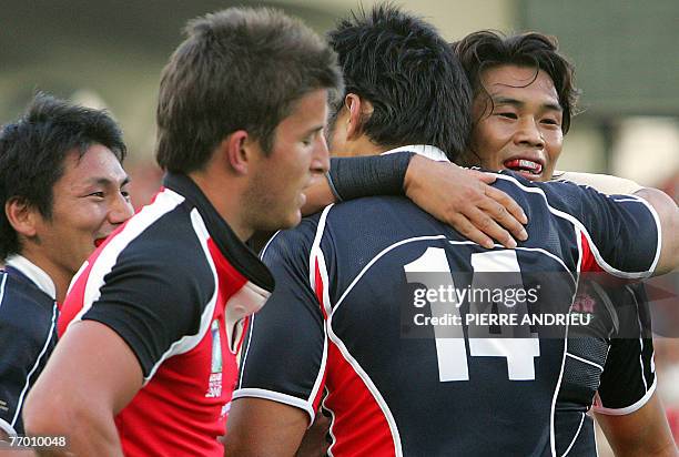 Japan's winger Kosuke Endo is congratulated by teammates after scoring a try during the rugby union World Cup group B match Canada vs. Japan, 25...