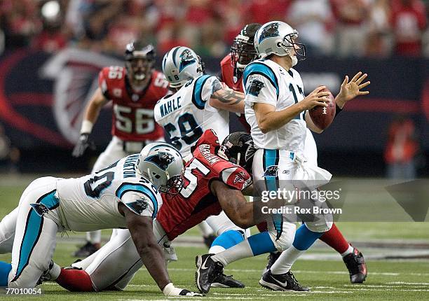 Defensive end John Abraham of the Atlanta Falcons sacks quarterback Jake Delhomme of the Carolina Panthers during the first half at Georgia Dome on...