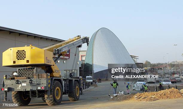 Soweto: shopping heaven comes to anti-apartheid bastion** South African workers put the finishing bit to the new shopping Maponya Mall in Soweto, 25...