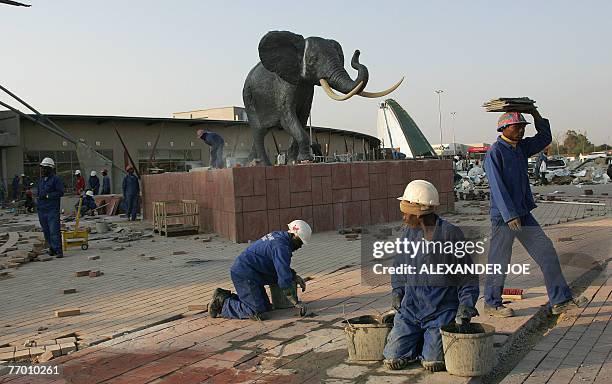 Soweto: shopping heaven comes to anti-apartheid bastion** South African workers put the finishing bit to the new shopping Maponya Mall in Soweto, 25...