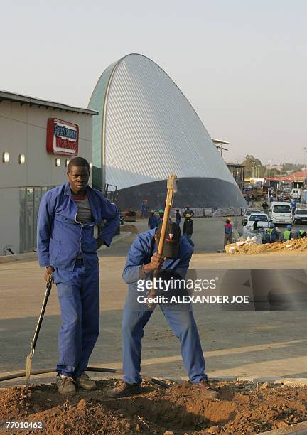 Soweto: shopping heaven comes to anti-apartheid bastion** South African workers are pictured on the site of the new shopping Maponya Mall in Soweto,...