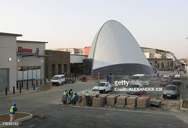 Soweto: shopping heaven comes to anti-apartheid bastion** South African workers are pictured on the site of the new shopping Maponya Mall in Soweto,...