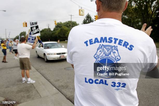 Members of Teamsters Local 332 in Flint watch over the picket line and show their support for members of the United Auto Workers as they strike in...