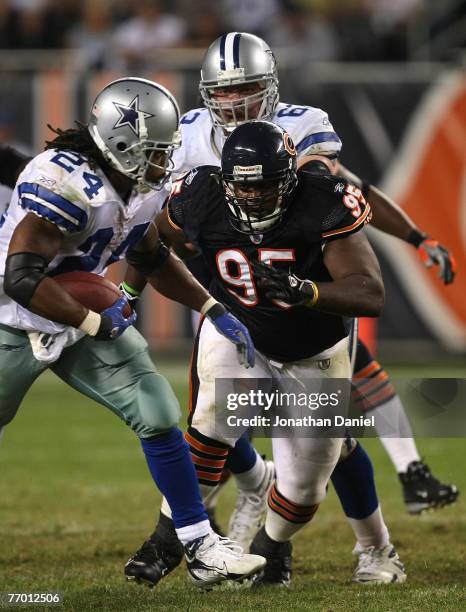 Anthony Adams of the Chicago Bears defends the run against Marion Barber of the Dallas Cowboys at Soldier Field on September 23, 2007 in Chicago,...