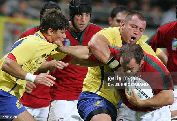 Portugal's prop and captain Joaquim Ferreira fights for the ball with Romania's prop Bogdan Balan during the rugby union World Cup group C match...