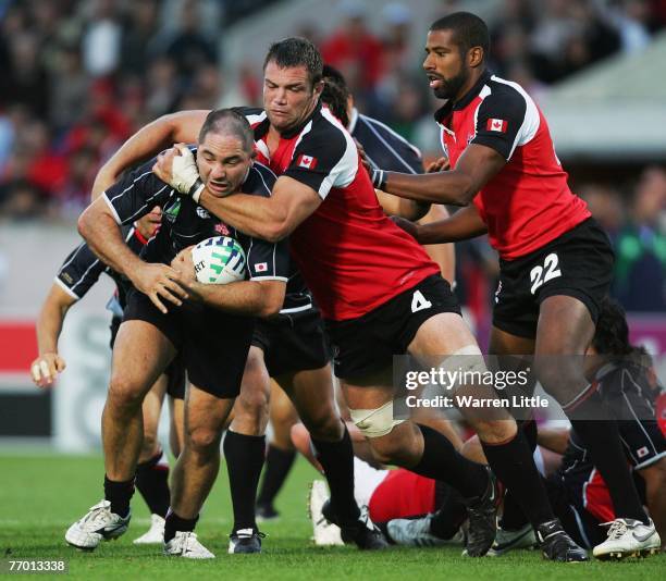 Philip O'Reilly of Japan is tackled by Mike Burak of Canada during the Rugby World Cup Pool B match between Canada and Japan at the Stade Chaban...