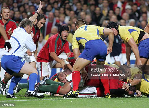 Portugal's prop and captain Joaquim Ferreira scores a try during the rugby union World Cup group C match Romania vs. Portugal, 25 September 2007 in...
