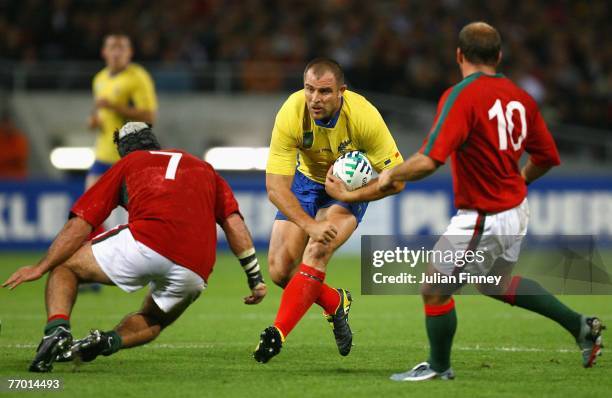 Florin Corodeanu of Romania looks for a way past Joao Uva and Duarte Cardoso Pinto of Portugal during Match Thirty of the Rugby World Cup 2007...