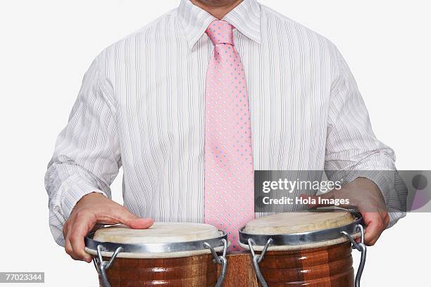 mid section view of a businessman playing bongo - drum top view stock-fotos und bilder