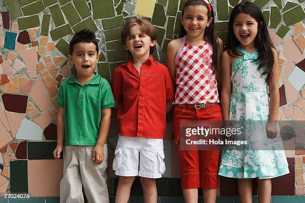 two boys and two girls leaning against a wall - free mosaic patterns stock-fotos und bilder