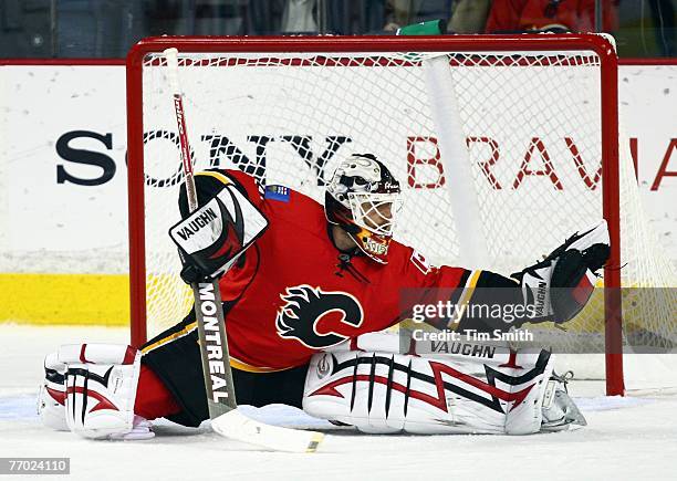 Goalie Miikka Kiprusoff of the Calgary Flames makes a glove save during the second period of pre-season NHL action against the San Jose Sharks on...