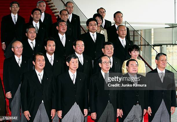 Newly appointed Japanese Prime Minister Yasuo Fukuda poses for photographers with the members of his cabinet at the Prime Minister's official...