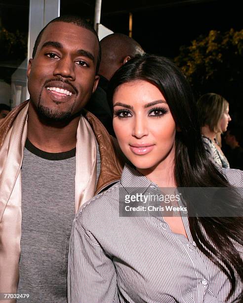 Music recording artist Kanye West, left, and socialite Kim Kardashian attend the grand opening of Intermix on September 25, 2007 in Los Angeles,...