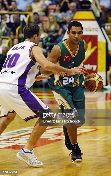 Michael Cedar of the Crocodiles looks to get past Jason Smith of the Kings the round two NBL match between the Townsville Crocodiles and the Sydney...