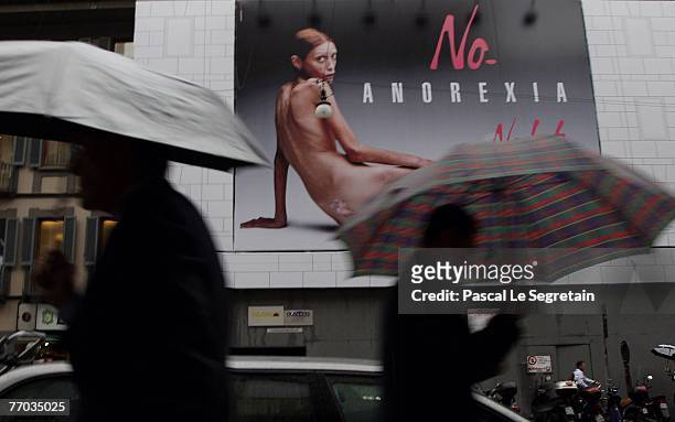 Pedestrian walks past a Nolita advertising poster during Spring/Summer 2008 fashion week on September 26, 2007 in Milan. Isabelle Caro had her naked...