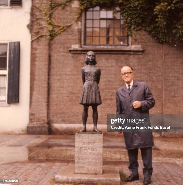 Victor Kugler stands next to the statue of Anne Frank in Utrecht, Netherlands, circa 1975. Kugler helped hide Anne and her family during the Nazi...