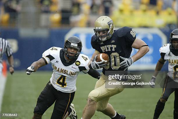 Tight end Nate Byham of the University of Pittsburgh Panthers runs with the football after catching a pass against defensive back Jeffery Jack of the...