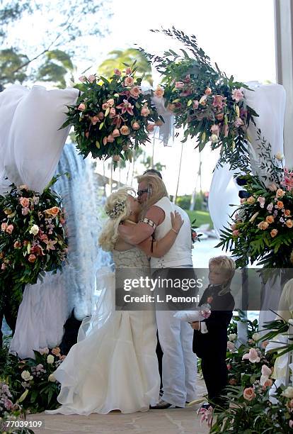 Beth Chapman wife of Bounty Hunter Duane "Dog" Chapman kiss under an archway of roses near the waterfall at the Hilton Waikoloa Village in Waikoloa,...