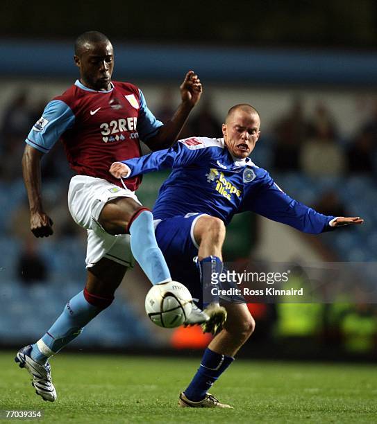 Zat Knight of Aston Villa is challenged by Iain Hume of Leicester during the Carling Cup tie between Aston Villa and Leicester City at Villa Park on...