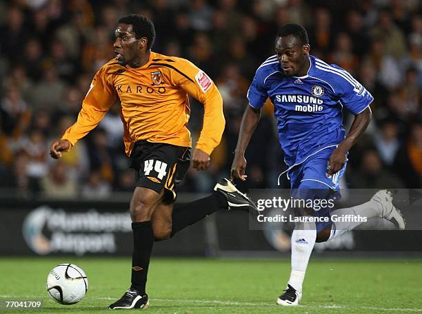 Michael Essien of Chelsea chases down Jay Jay Okocha of Hull durng the Carling Cup Third Round Match between Hull City and Chelsea at the KC Stadium...