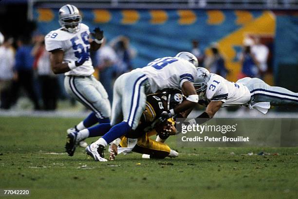 Pittsburgh Steelers wide receiver Andre Hastings is tackled by Cowboys defensive back Darren Woodson during the Steelers 27-17 loss to the Dallas...