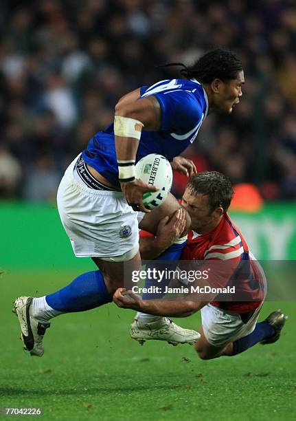 Owen Lentz of USA tackles Alesana Tuilagi of Samoa during match thirty two of the Rugby World Cup 2007 between Samoa and USA at the Stade Geoffroy...