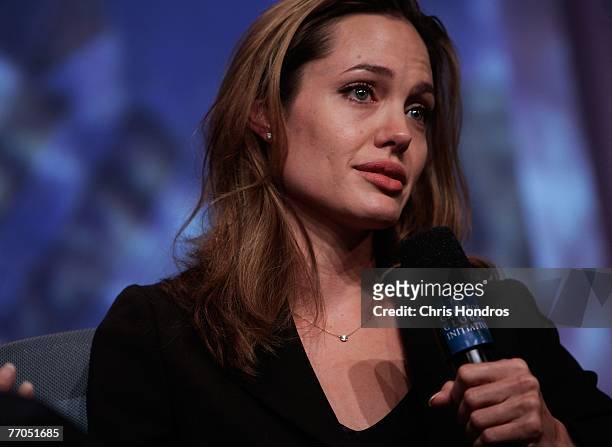 Actress Angelina Jolie tears up while telling a refugee's story during a panel discussion about education at the Clinton Global Inititative annual...