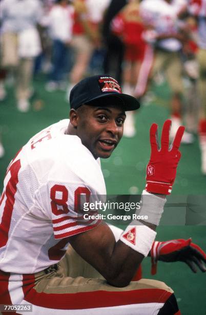 Wide receiver Jerry Rice of the San Francisco 49ers counts his Super Bowl record three touchdown receptions as he poses for a photo in Super Bowl...