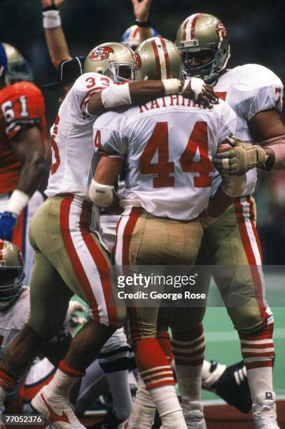 Full back Tom Rathman of the San Francisco 49ers celebrate with teammates after scoring a touchdown in Super Bowl XXIV against the Denver Broncos at...
