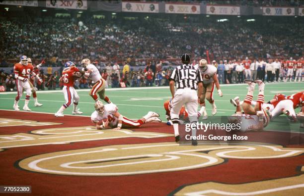 Full back Tom Rathman of the San Francisco 49ers falls in the end zone for a touchdown in Super Bowl XXIV against the Denver Broncos at Louisiana...