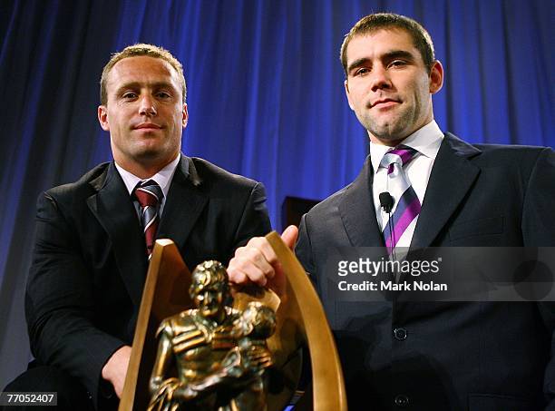 Manly Sea Eagles captain Matt Orford and Melbourne Storm captain Cameron Smith pose with the NRL Premiership trophy during the 2007 NRL Grand Final...