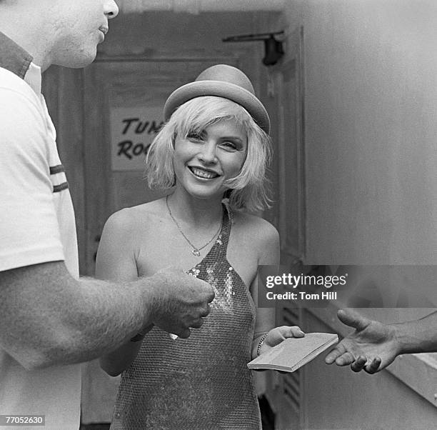 Singer Debbie Harry of Blondie signs autographs outside her dressing room before performing at the Fabulous Fox Theater on July 28, 1979 in Atlanta,...
