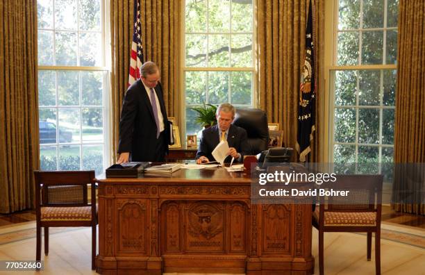 President George W. Bush and Counselor Dan Bartlett work together in the Oval Office October 26, 2006