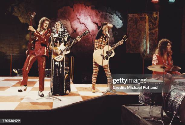 English glam rock group Slade perform on the BBC TV show Top of the Pops in London in 1973. The group are, from left to right: bassist Jim Lea,...