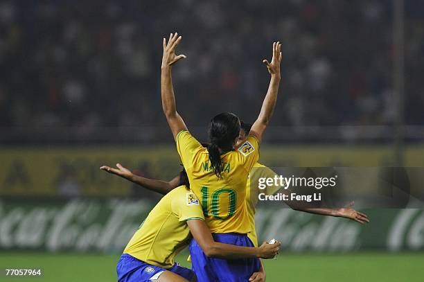 Marta of Brazil celebrates the winning with Monica after the Womens World Cup 2007 Semi Final match between USA and Brazil at Hangzhou Dragon Stadium...