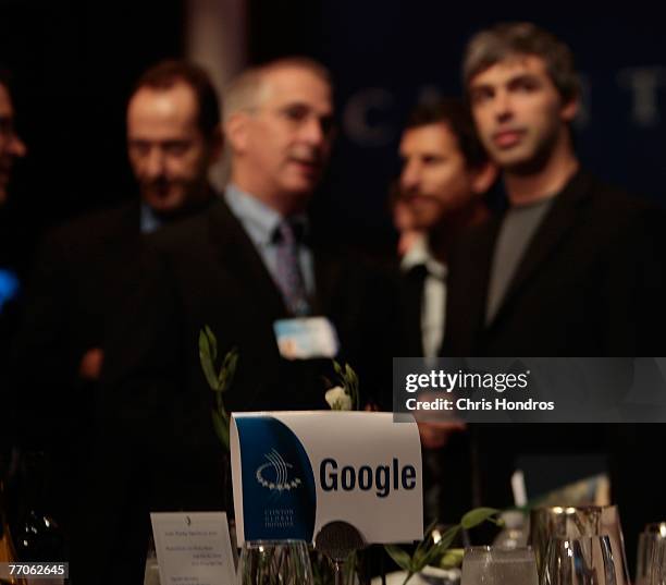 Co-founder of Google, Larry Page , stands with others at the Google table between sessions of the Clinton Global Inititative annual meeting September...