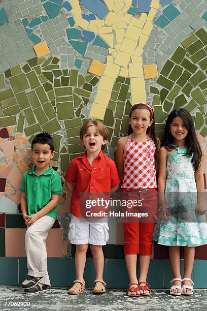 two boys and two girls leaning against a wall - free mosaic patterns fotografías e imágenes de stock