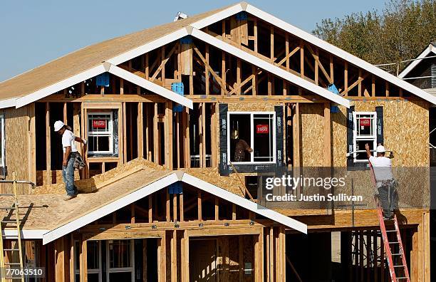 Workers install windows on a new home under construction at a housing development September 27, 2007 in Richmond, California.Tthe Commerce Department...