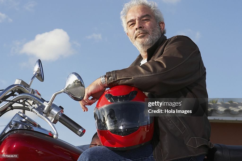 Portrait of a mature man sitting on a motorcycle