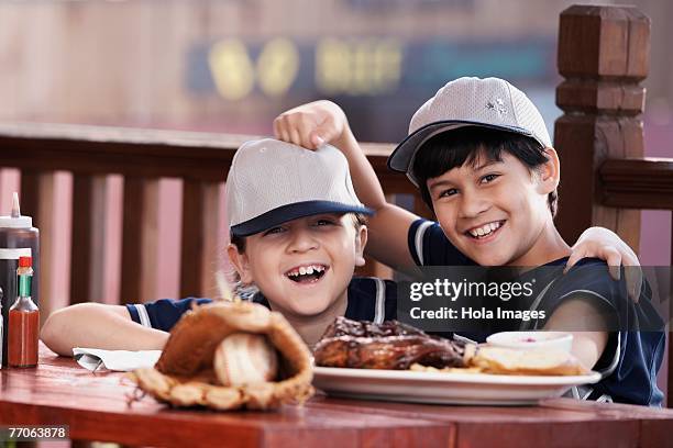 portrait of a boy and a girl smiling - baseball strip stock-fotos und bilder