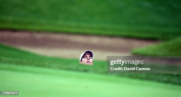 Jim Furyk of the U.S. Team looks from the deep bunker by the green for his third shot to the 12th hole during the round one foursome matches at the...