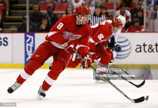 Matt Ellis of the Detroit Red Wings heads up ice in front of teammate Tomas Kopecky during the second period against the Tampa Bay Lightning during a...