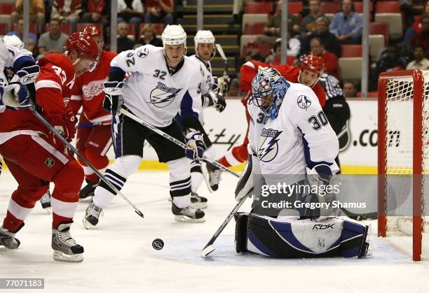 Marc Denis of the Tampa Bay Lightning makes a third period save in front of Kris Draper of the Detroit Red Wings during a preseason game September...