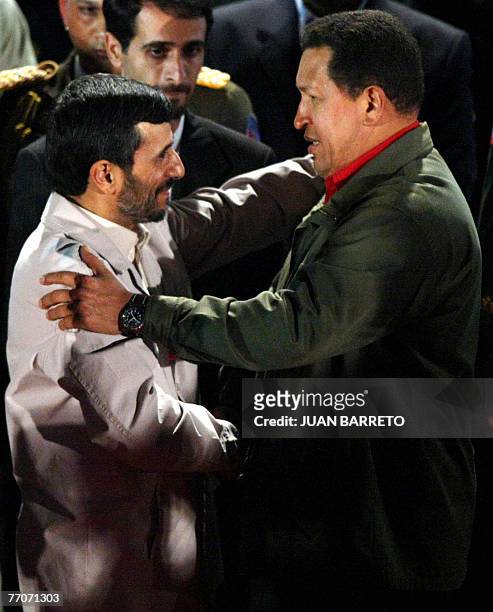 Venezuelan president Hugo Chavez and his Iranian counterpart Mahmoud Ahmadinejad greet each other 27 September at the Miraflores presidential palace...