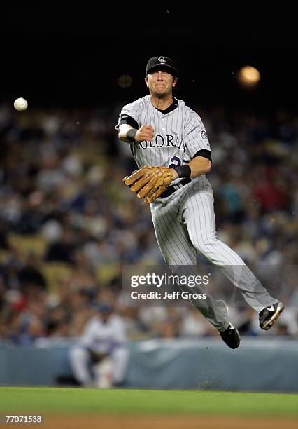 Shortstop Troy Tulowitzki of the Colorado Rockies makes a leaping throw to first base to record the out on a ball hit by Chin-Lung Hu of the Los...