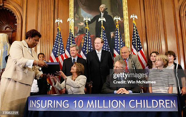 Speaker of the House Nancy Pelosi hands signed Children's Health Insurance Program legislation to House Clerk Lorraine Miller for delivery to U.S....