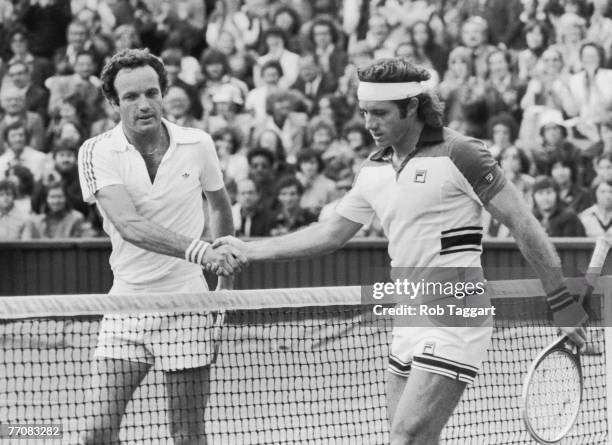 Dutch tennis player Tom Okker shakes hands with Argentina's Guillermo Vilas, after beating him in the mens' singles on centre court at Wimbledon,...