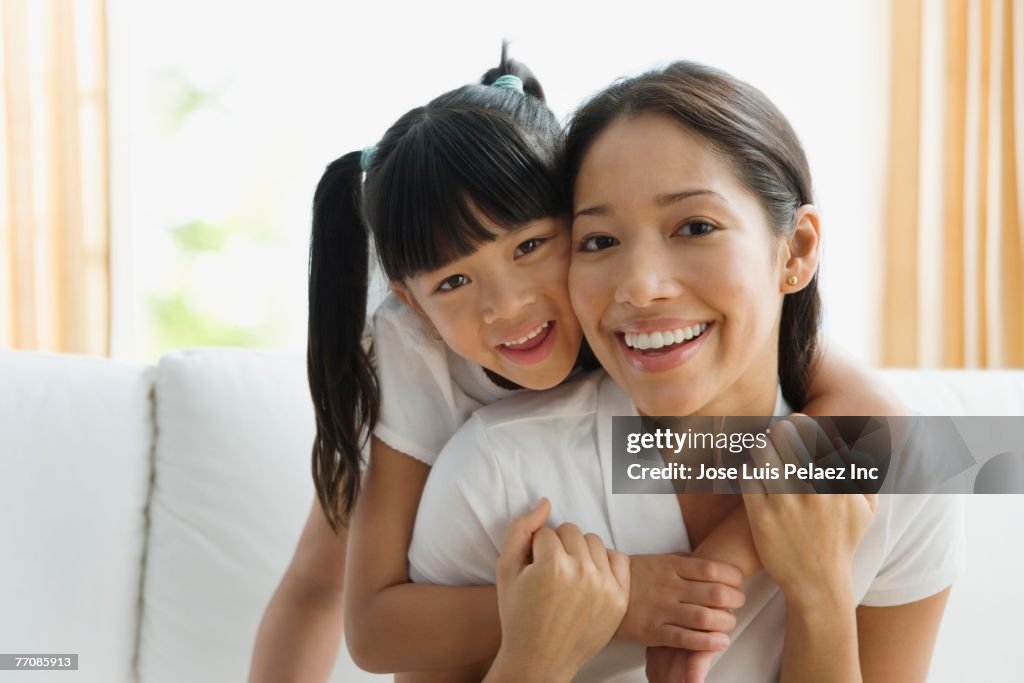 Pacific Islander mother and daughter hugging