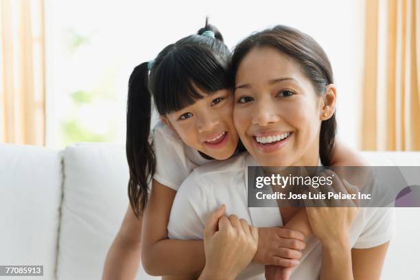 pacific islander mother and daughter hugging - filipino woman smiling stock pictures, royalty-free photos & images